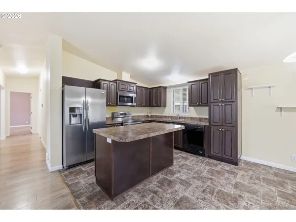 a kitchen with stainless steel appliances granite countertop a refrigerator stove and oven