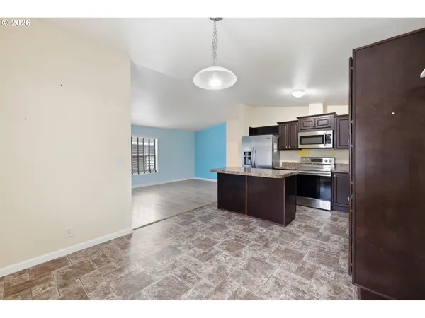 a kitchen with kitchen island a counter top space appliances and cabinets