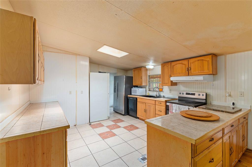 210 7th Street Blanket, TX 76432 - Photo 10 of 33 a kitchen with a sink stove and refrigerator