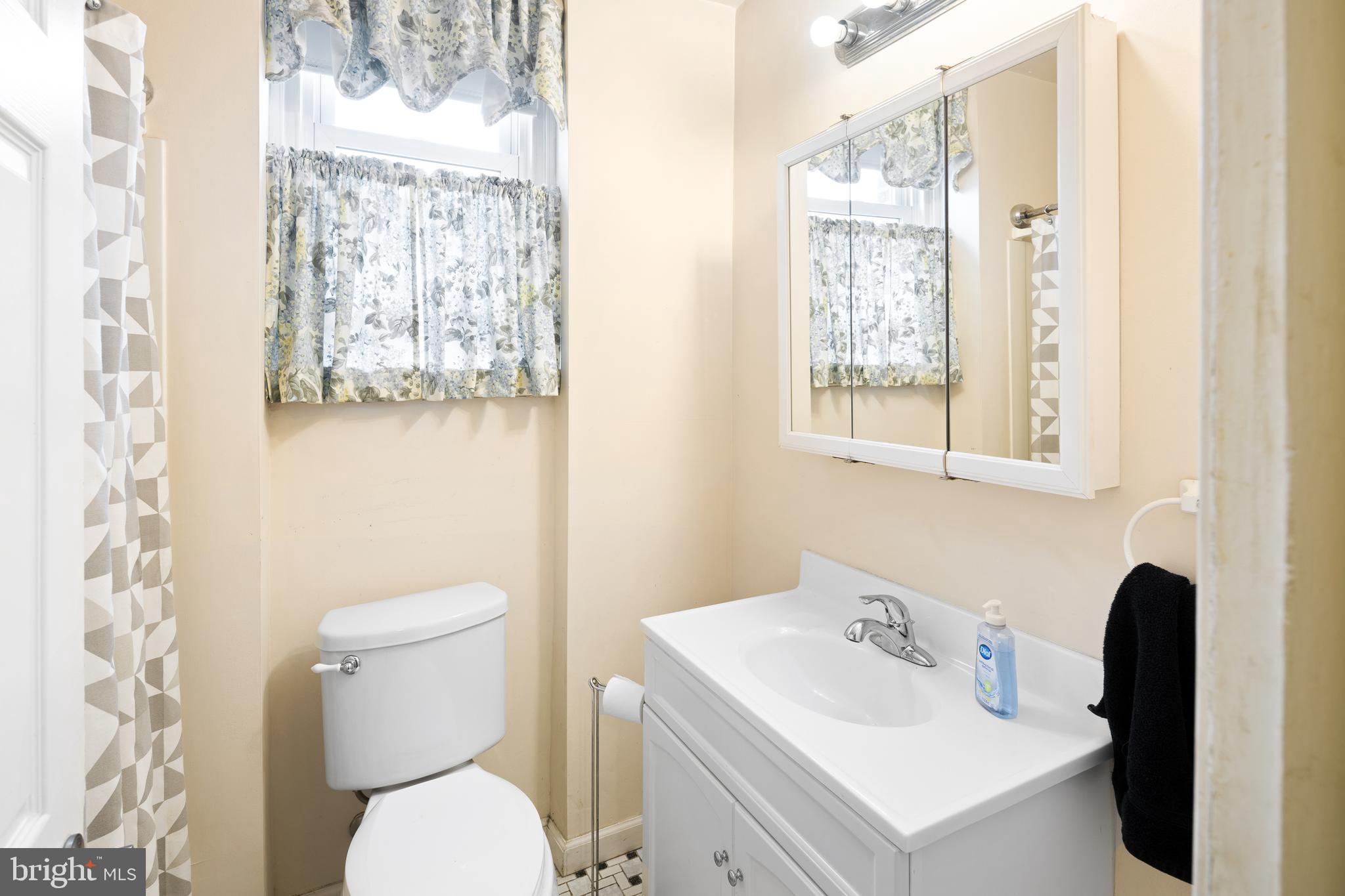 7851 Horrocks Street Philadelphia, PA 19152 - Photo 7 of 15 a bathroom with a toilet sink and mirror