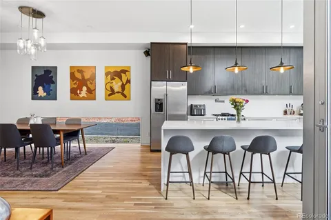 a dining room with wooden floor and entrance