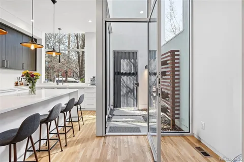 a kitchen with stainless steel appliances granite countertop a sink and a refrigerator