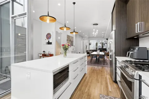 a kitchen with a table chairs stove and cabinets