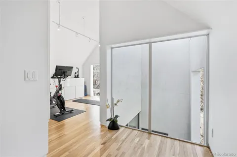 a bedroom with a bed and a flat tv screen on the table