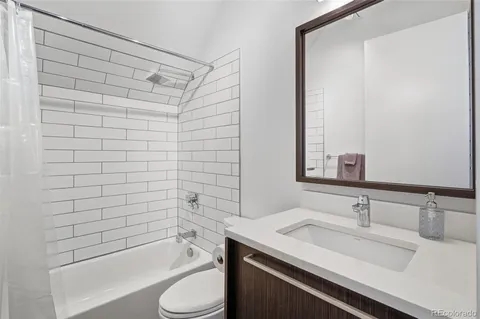 a bathroom with a shower and a sink