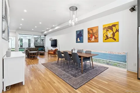 a view of a dining room with furniture a chandelier and wooden floor