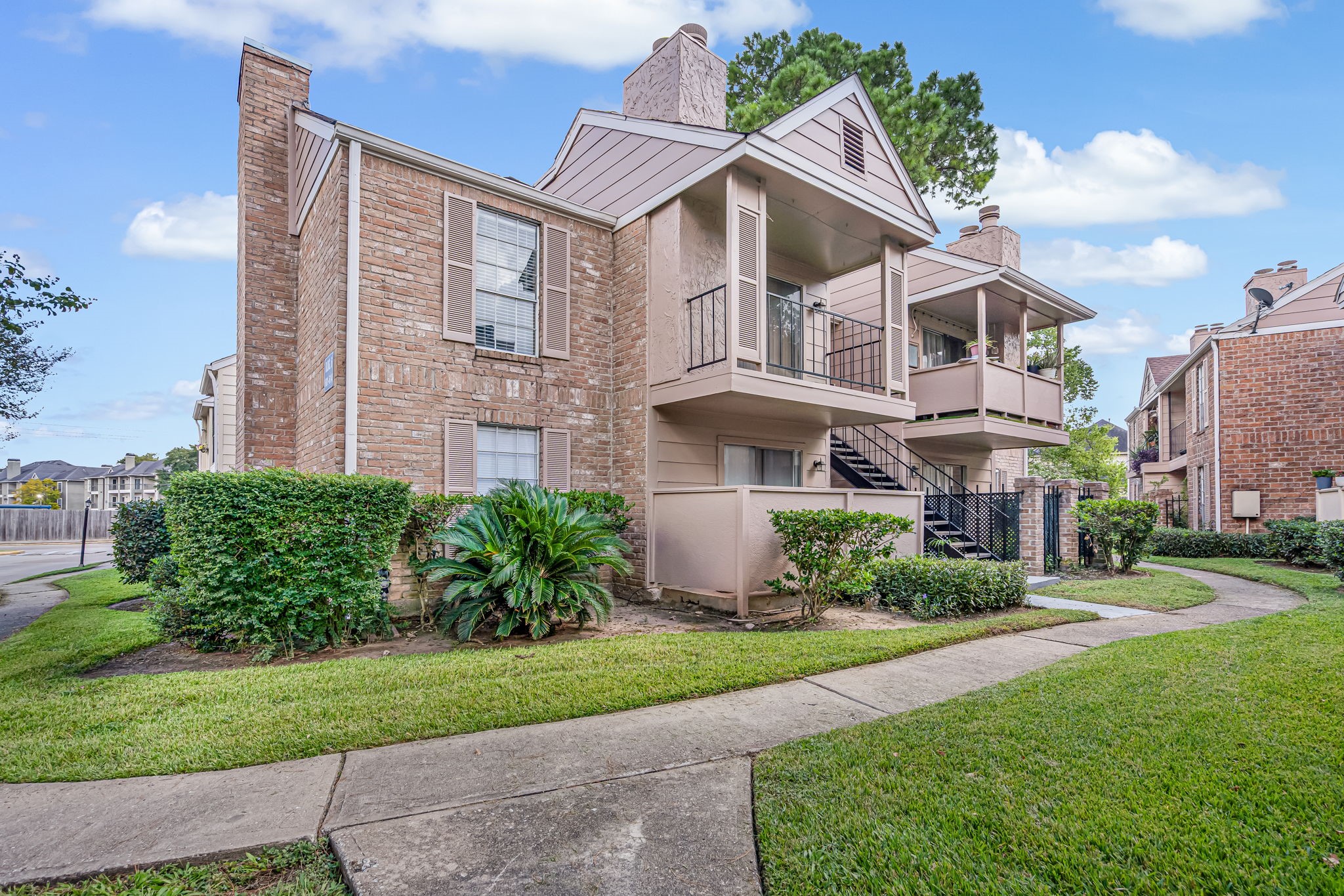 a front view of a residential houses with yard and green space