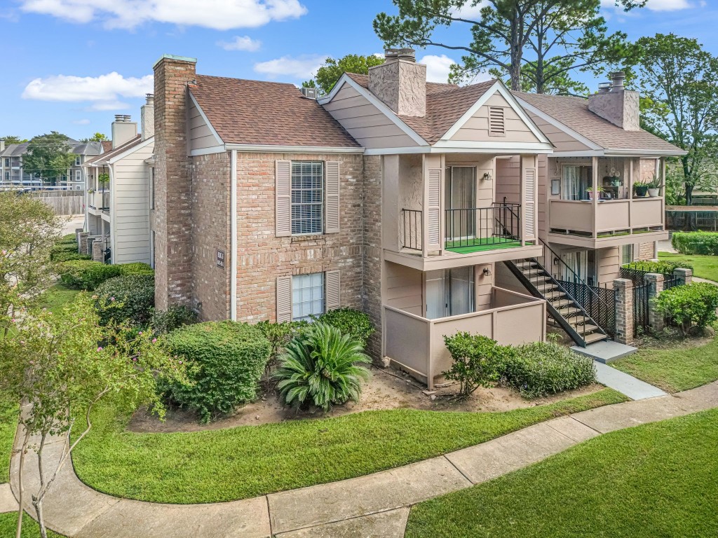 2800 Jeanetta Street, Unit 602 Houston, TX 77063 - Photo 2 of 29 a view of a white house next to a yard with plants and trees