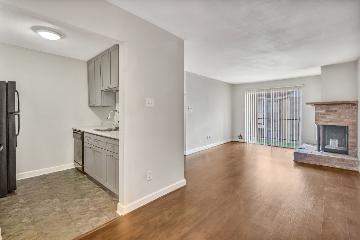2800 Jeanetta Street, Unit 602 Houston, TX 77063 - Photo 27 of 29 an empty room with wooden floor cabinet and a fireplace