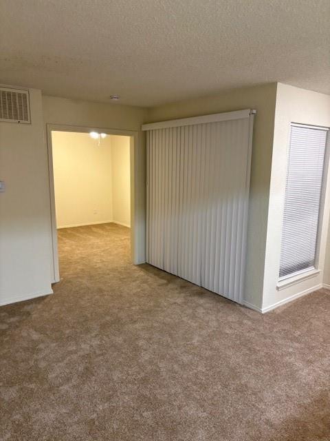 9813 Walnut Street, Unit 303 Dallas, TX 75243 - Photo 3 of 6 an empty room with a window