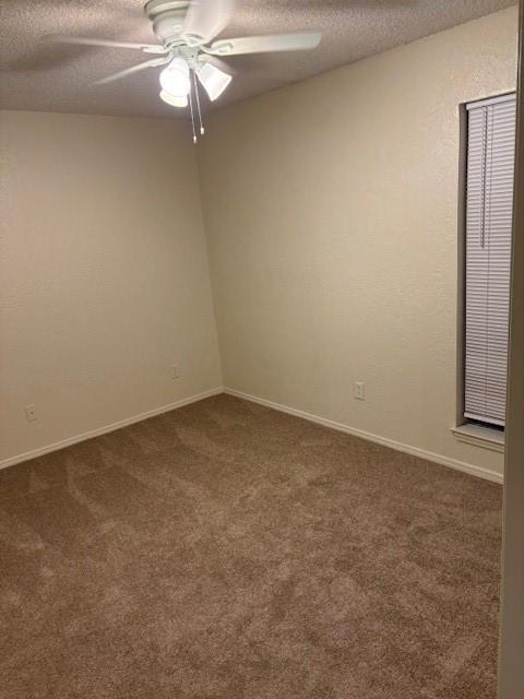 9813 Walnut Street, Unit 303 Dallas, TX 75243 - Photo 5 of 6 an empty room with a fan and a fan
