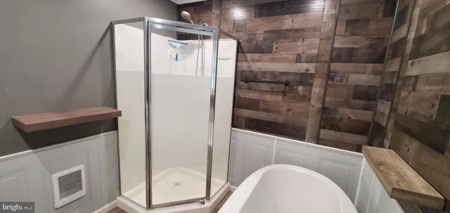 a bathroom with a shower and mirror