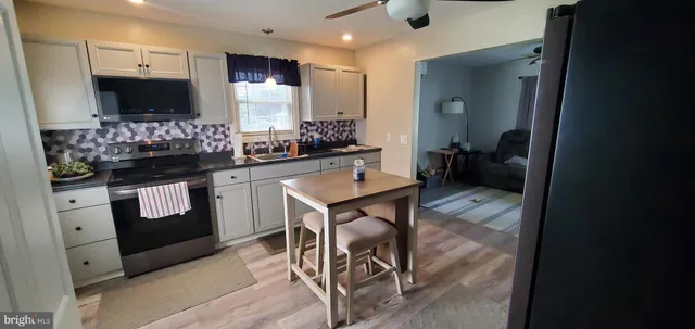 a kitchen with a sink cabinets and window