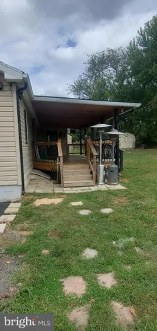 a view of a swimming pool with a bench and trees