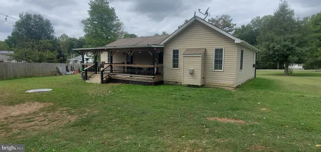 a front view of a house with a garden and yard