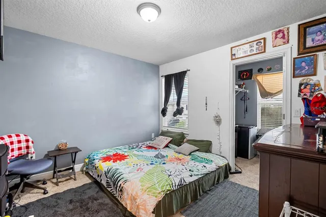 a bedroom that has a bed and a chair in it