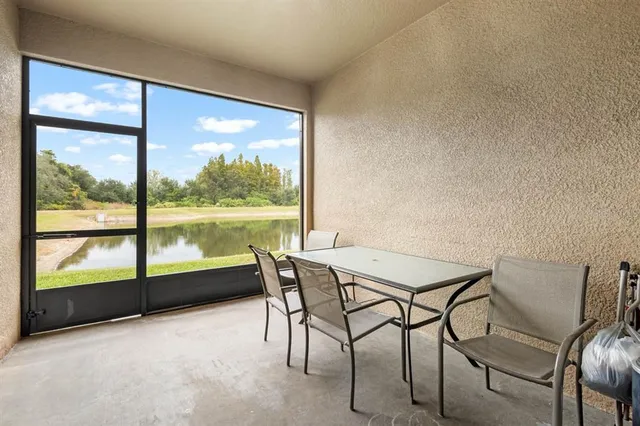 a view of a room with a table and chairs