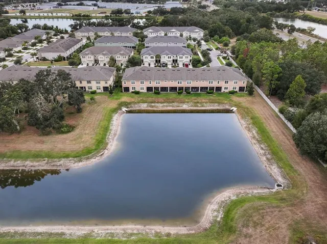 an aerial view of residential houses with outdoor space and swimming pool