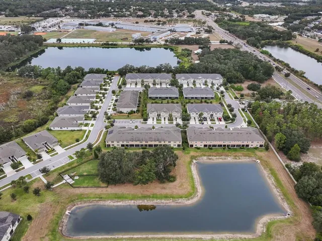 an aerial view of residential houses with outdoor space