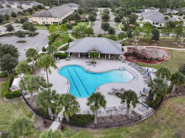 an aerial view of a house with garden space and lake view