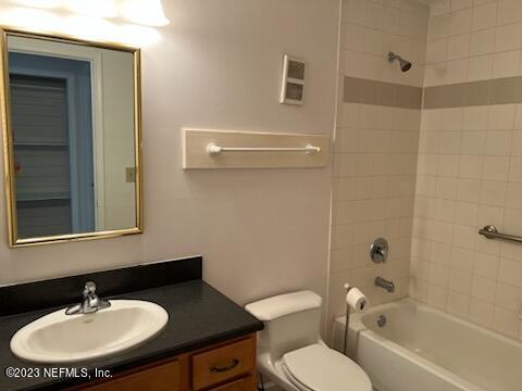 400 Sandiron Circle, Unit 418 Ponte Vedra Beach, FL 32082 - Photo 11 of 25 a bathroom with a sink toilet a mirror and shower