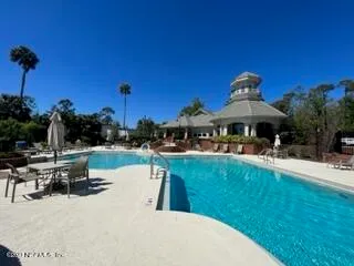 a view of a swimming pool with a table and chairs
