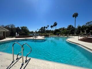 400 Sandiron Circle, Unit 418 Ponte Vedra Beach, FL 32082 - Photo 24 of 25 a view of a swimming pool with a table and chairs