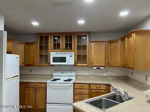 a kitchen with a stove a sink and a refrigerator