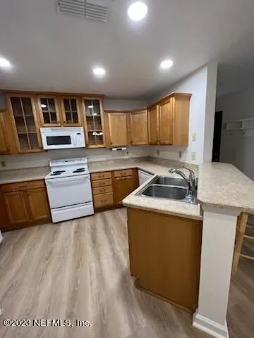 a kitchen that has a sink and a stove in it