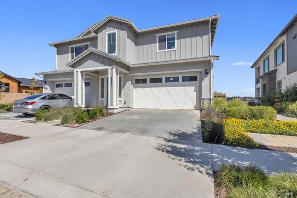 a front view of a house with a yard and garage