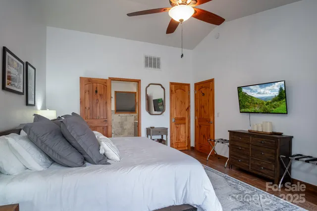 a bedroom with a bed and a flat screen tv
