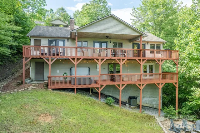 an aerial view of a house with swimming pool and chairs