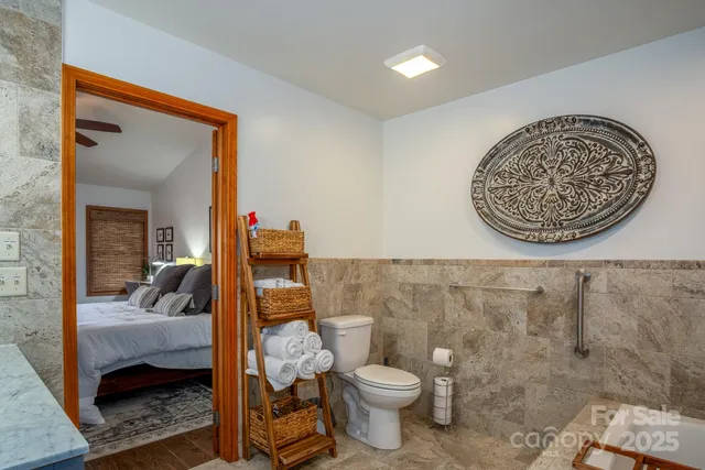 a bathroom with a toilet and a mirror