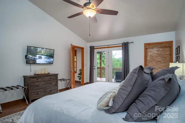a bed room with a bed window and a chandelier