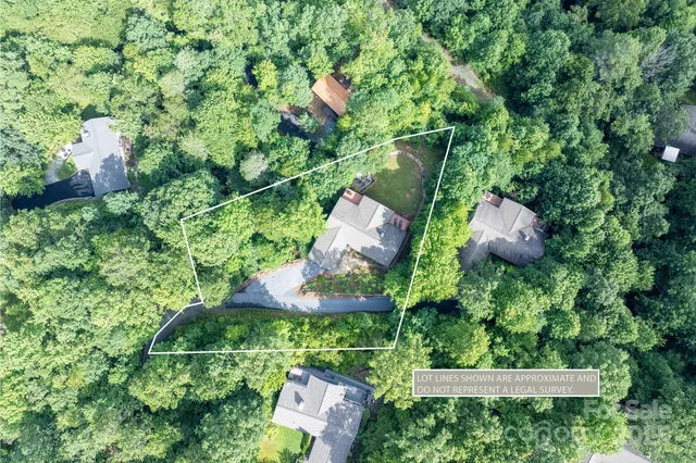 an aerial view of a house with a yard and outdoor seating