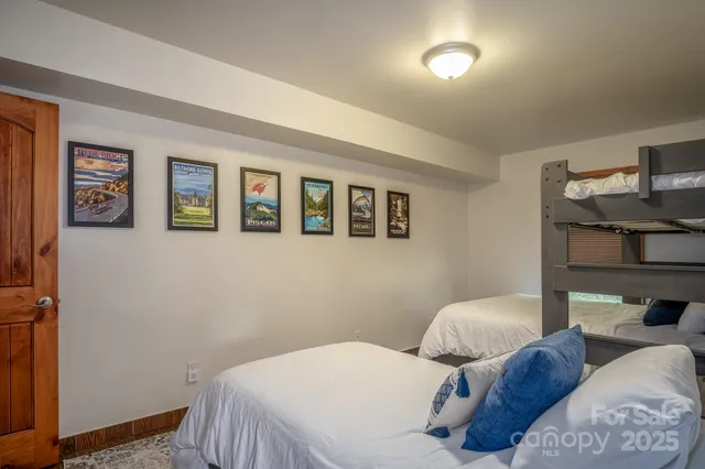 a bedroom with two beds and painted walls