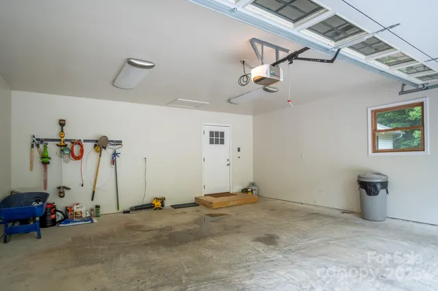 a room with a fireplace and chandelier