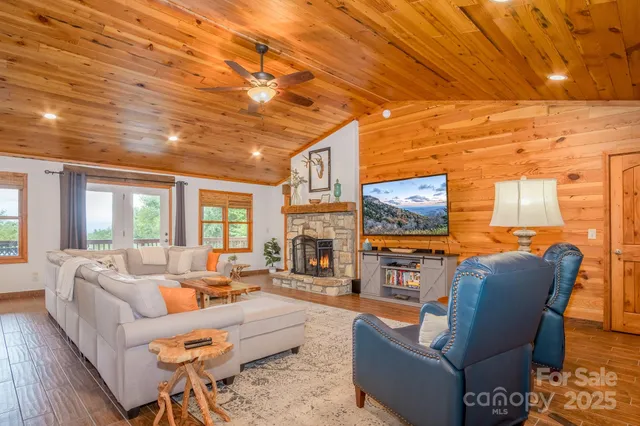 a living room with fireplace furniture and a flat screen tv