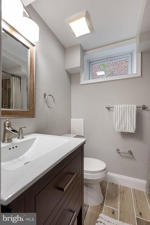 2208 Shepherd Street Northeast Washington, DC 20018 - Photo 11 of 19 a bathroom with a sink a toilet a mirror and vanity