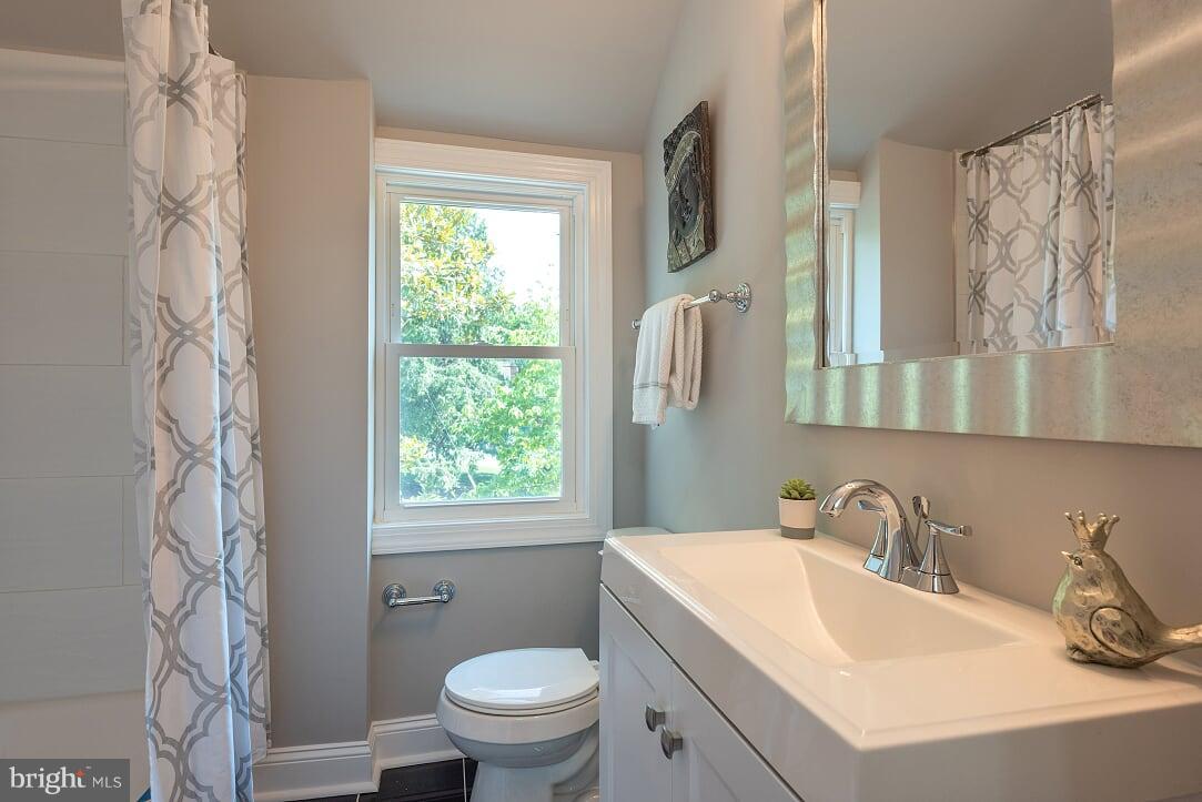 2208 Shepherd Street Northeast Washington, DC 20018 - Photo 15 of 19 a bathroom with a sink toilet and window