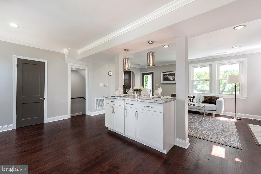 2208 Shepherd Street Northeast Washington, DC 20018 - Photo 7 of 19 a living room with kitchen island granite countertop wooden floor stainless steel appliances and dining table