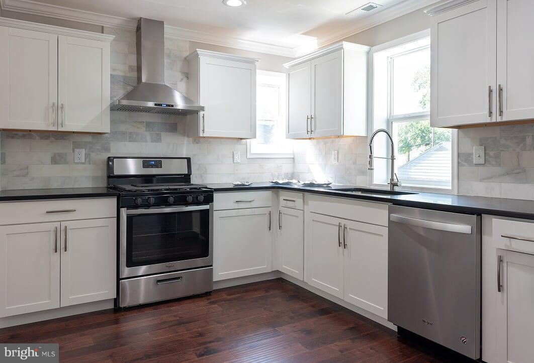 2208 Shepherd Street Northeast Washington, DC 20018 - Photo 9 of 19 a kitchen with granite countertop white cabinets and appliances