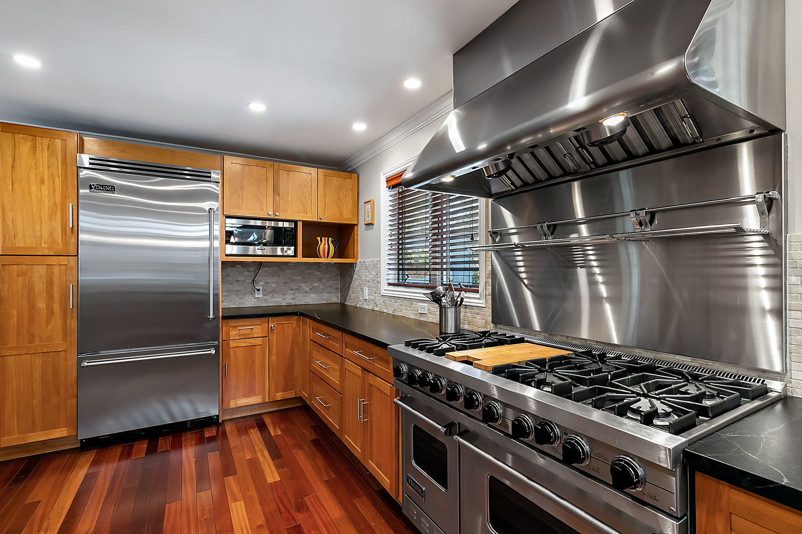 379 Audubon Road Riverside, IL 60546 - Photo 12 of 37 a kitchen with stainless steel appliances granite countertop a stove and a refrigerator
