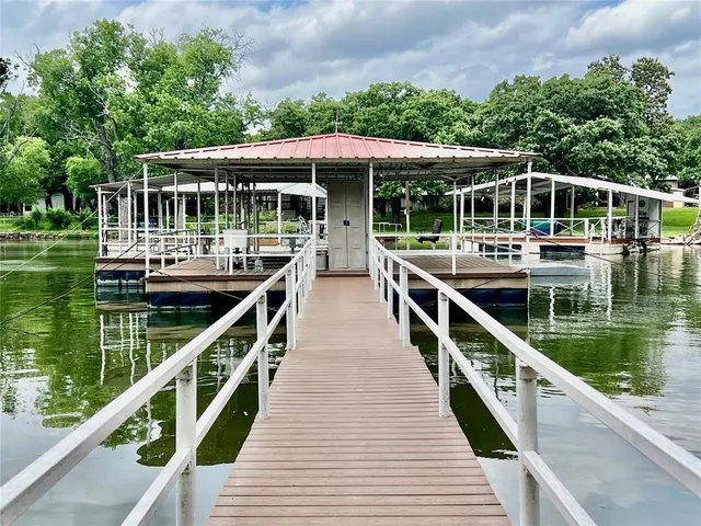 a view of house with swimming pool and outdoor seating