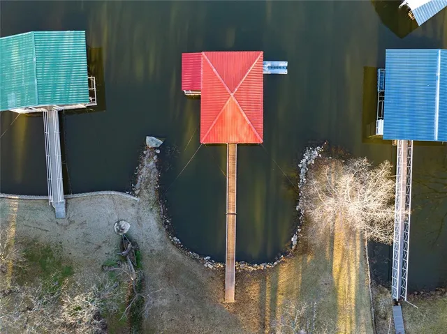 a room that has painting on the wall and a lamp