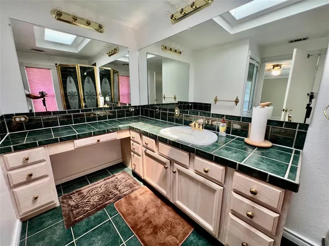 a kitchen with stainless steel appliances granite countertop a sink and cabinets