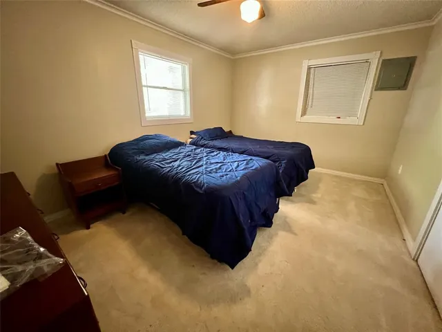 a bedroom with bed and window