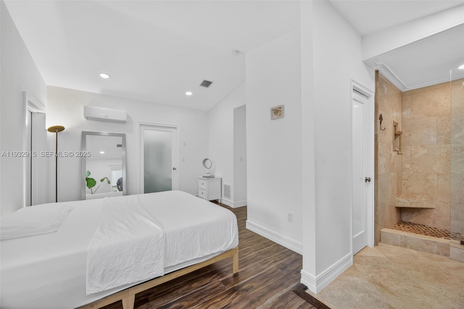 11260 Southwest 48th Street Miami, FL 33165 - Photo 24 of 48 a large bedroom with a bed and a chandelier