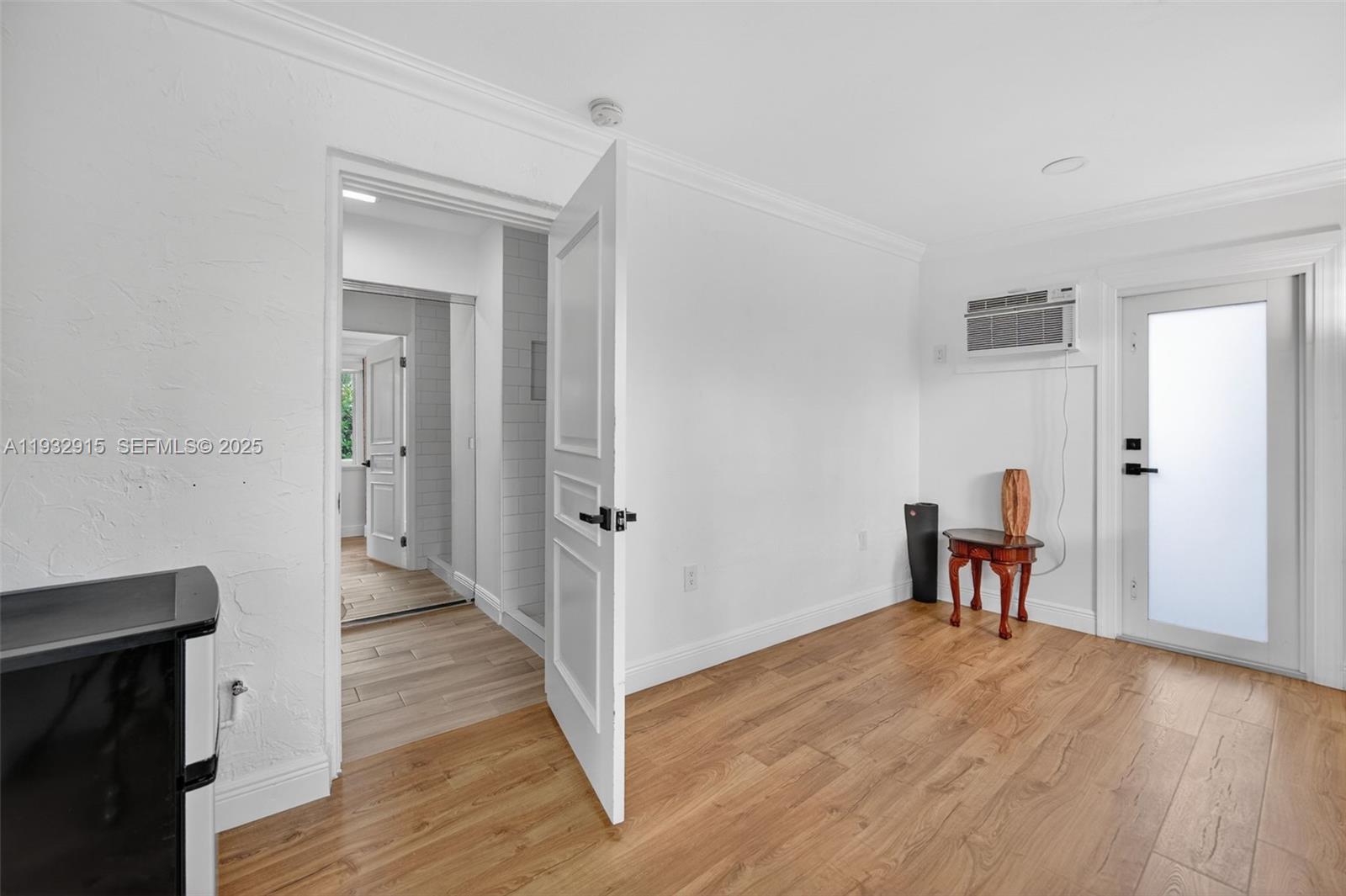 11260 Southwest 48th Street Miami, FL 33165 - Photo 33 of 48 a view of a hallway with wooden floor and a living room