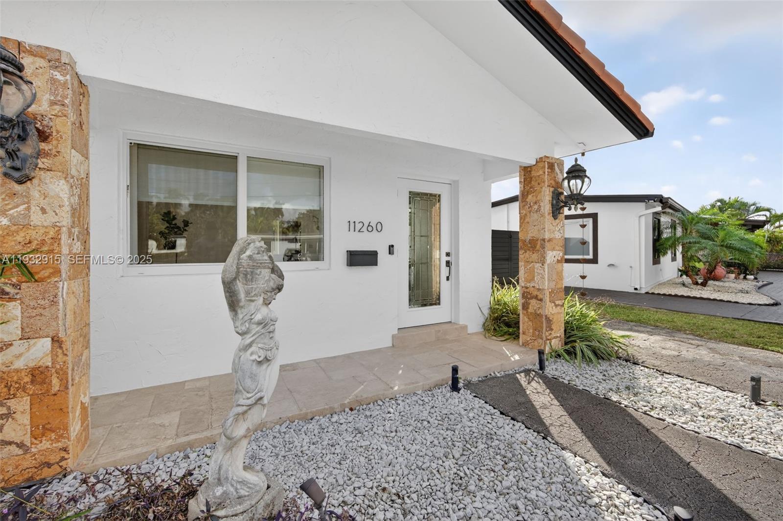 11260 Southwest 48th Street Miami, FL 33165 - Photo 4 of 48 a front view of a house with garden